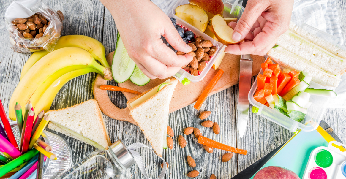 Healthy lunch preparation with fruits, nuts and vegetables